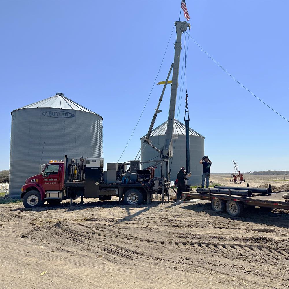 Picture of people digging a well on a farm.